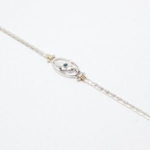 Pulsera con cadena paris dos apliques de oro medalla ovalada central con flor con cubic azul